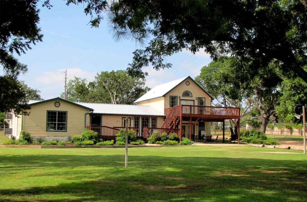 Image of the Lake House exterior and grounds located at one of the best family resorts in Texas, Willow Point.