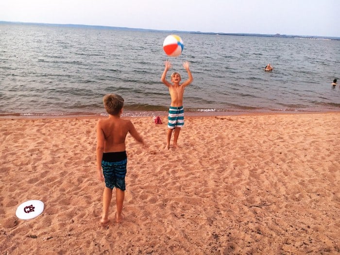 Image of our younger guests enjoying some outdoor activities on the sandy beaches outside their lake cabin rentals in the Texas Hill Country. Willow Point is the best family friendly resort in Texas.